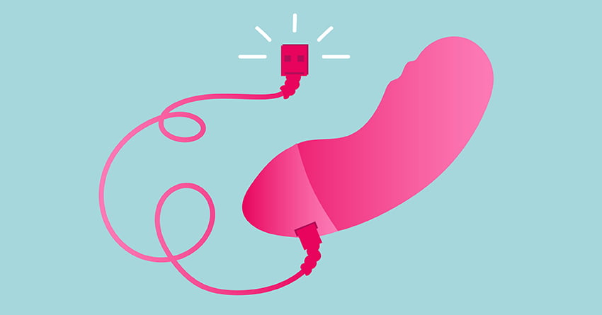 A small vibrator connected to its charging cable. 