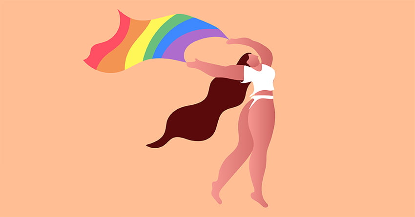 A woman proudly waving the pride flag. 