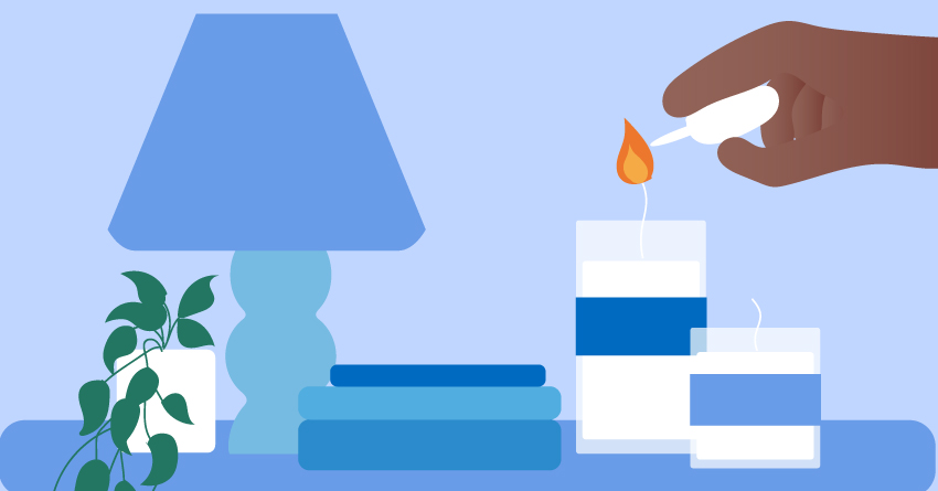 A person lighting up a candle. 