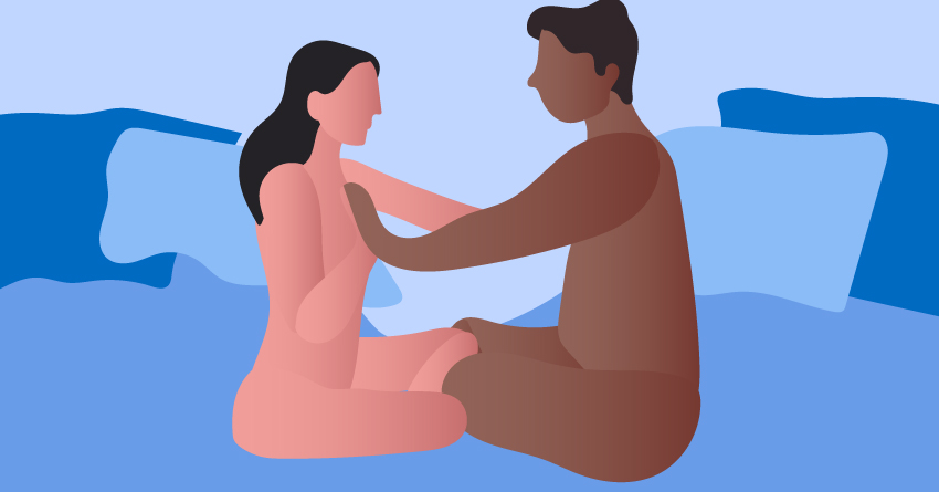 A naked couple sitting on the bed face-to-face and touching each other. 