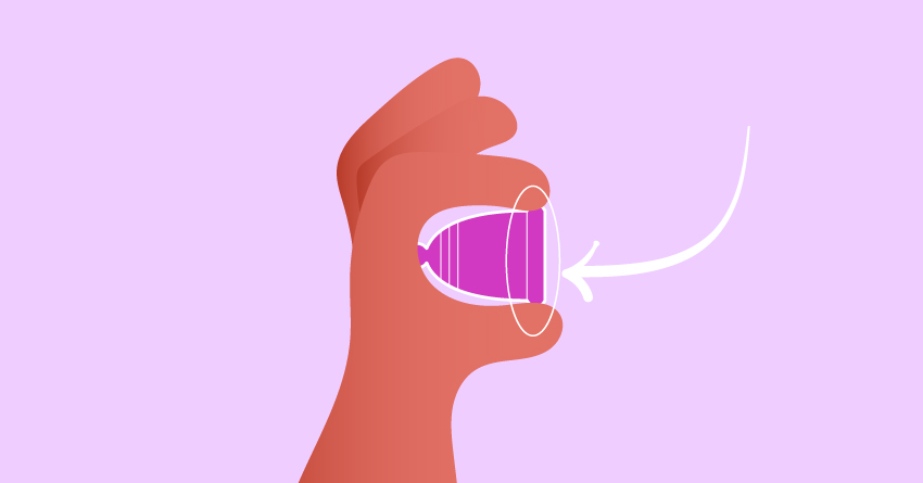 A person holding a menstrual cup. 