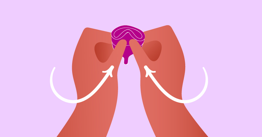 Someone folding a menstrual cup. 