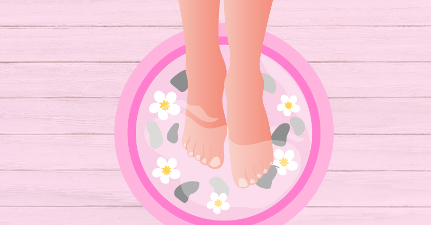 Feet soaked in water with essential oils and flowers. 