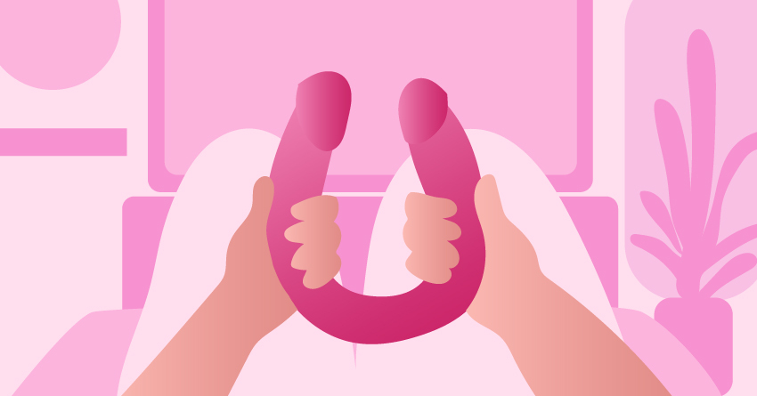 A hand holding a double-ended dildo. 