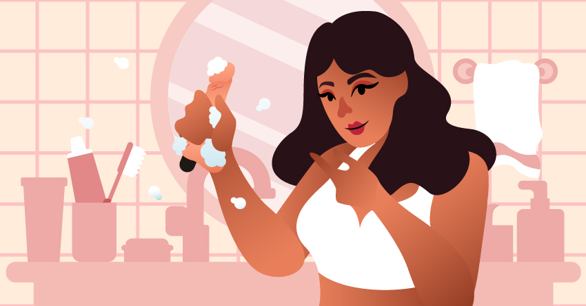 A woman washing off her vibrating dildo. 