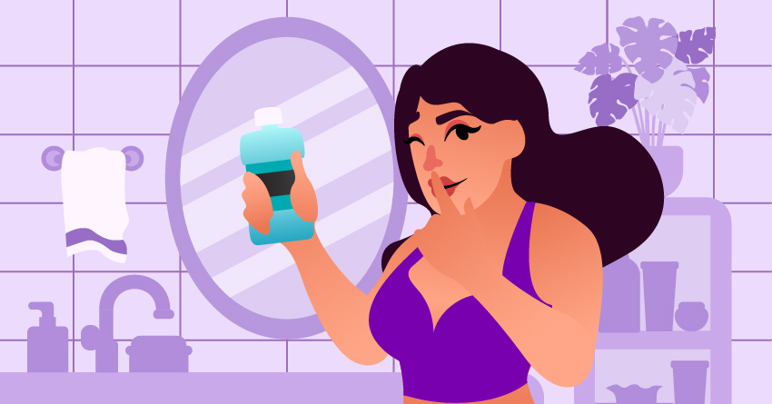 A smirking woman holding a bottle of mouthwash. 