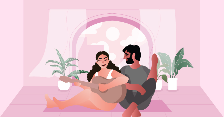 A couple sitting on the floor, writing a song together. 
