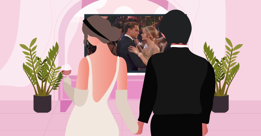 A couple in fancy clothes, watching a film at home. 