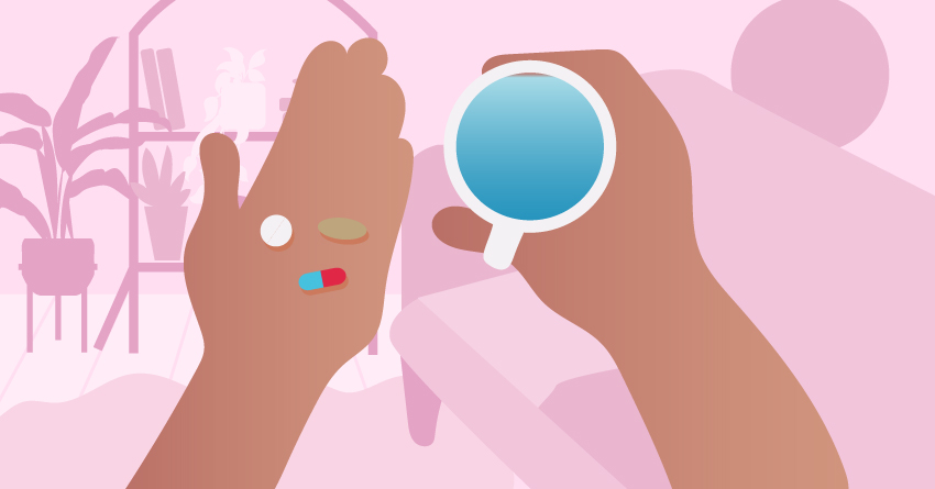 A person holding 3 pills and a glass of water. 