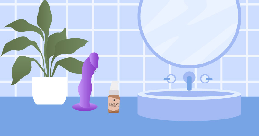 A sink with a dildo and a bottle of lubricant. 