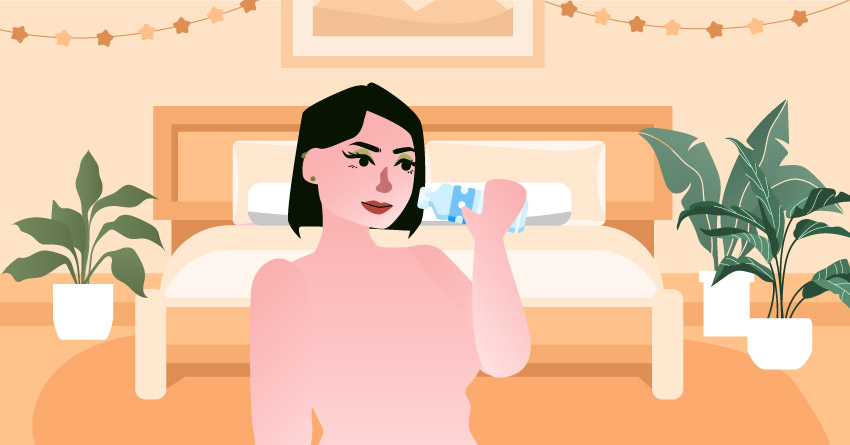 A naked woman drinking bottled water. 