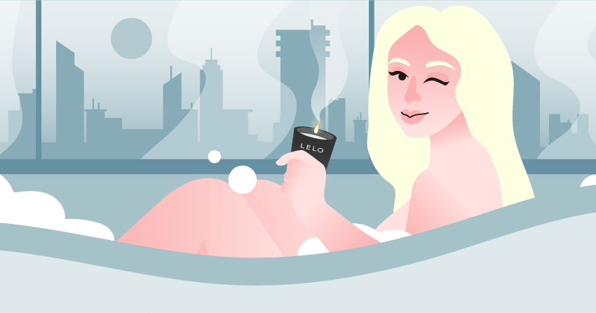 A woman sitting in a bathtub, holding a massage candle. 