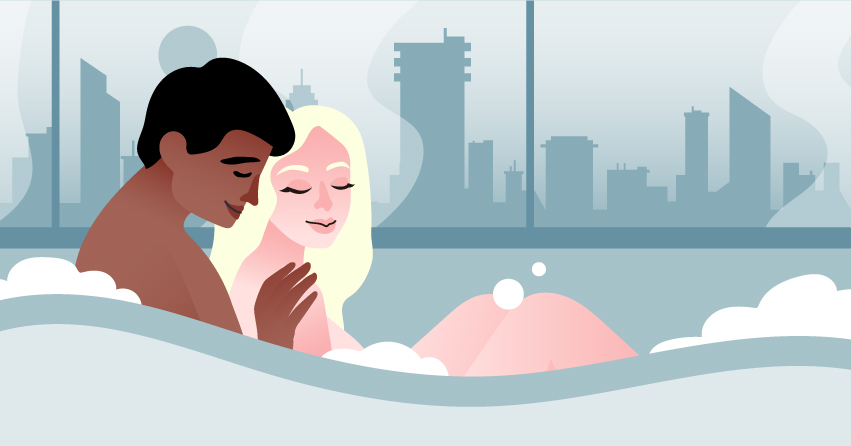 A couple cuddling in the bathtub. 