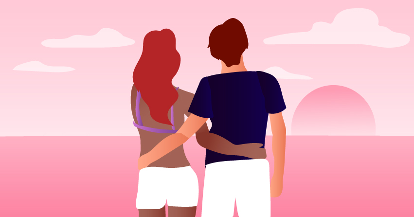 A couple looking into the sunset, holding each other's backs. 