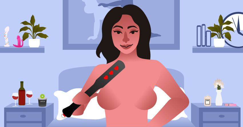 A naked woman holding a BDSM paddle. 