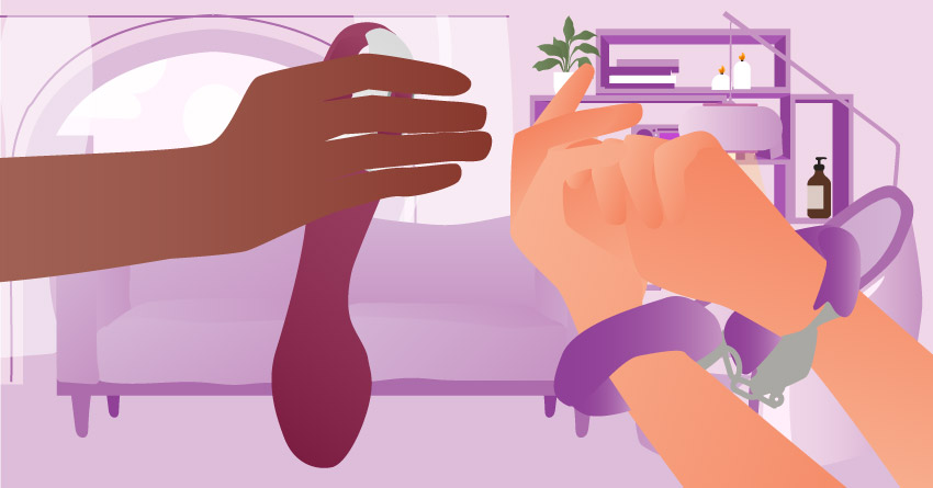 A person holding a g-spot vibrator while their partner is handcuffed. 