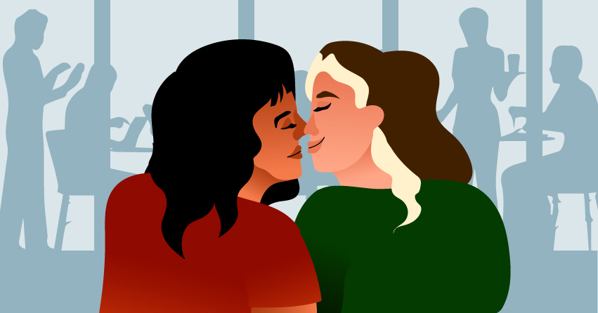 Two women about to share a kiss. 