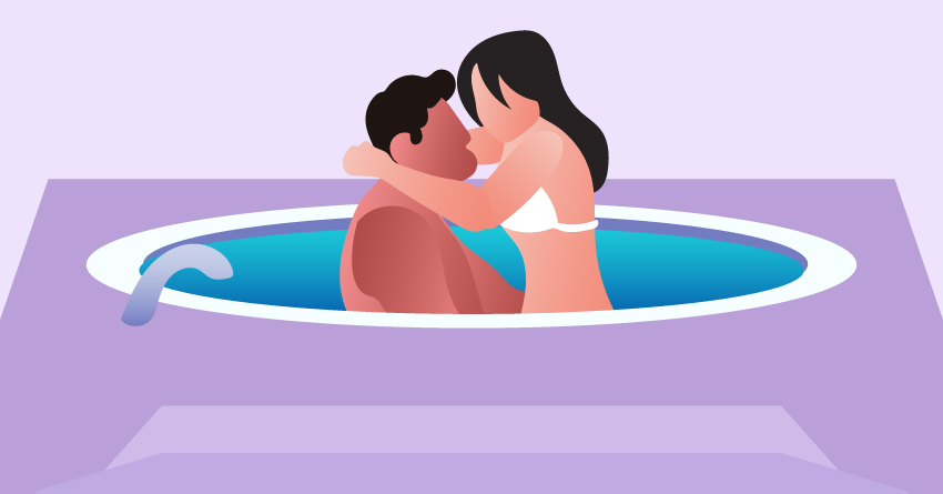 A couple having sex in a hot tub. 