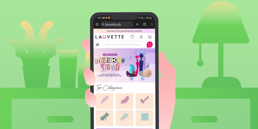 A hand holding a smartphone, with the screen showing the Lauvette website, a sex toy store in the Philippines.